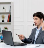 customer-service-cute-guy-grey-suit-with-computer-headset-holding-fists-up (1)