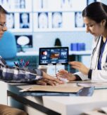 Healthcare professional uses an oximeter to measure the oxygen levels for a patient at check up, diagnostic tools for accurate medical advice. Monitoring pulse and saturation with indicator.